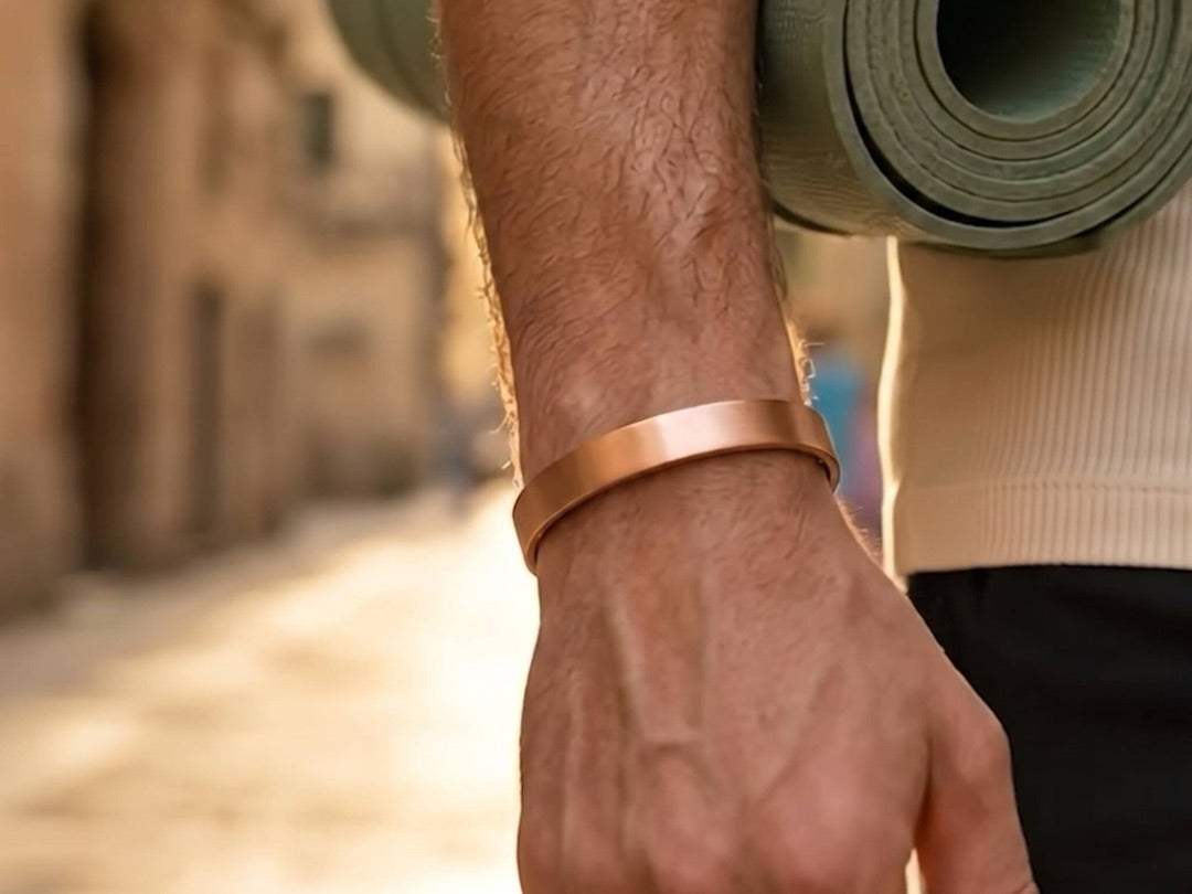 Quantum copper bracelet worn on the wrist while carrying a yoga mat